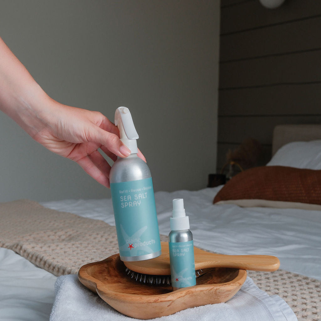 A full size sea salt spray and travel size sea salt spray that can be refilled after a trip reducing plastic waste. 